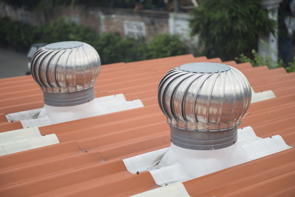 Two Silver Roof Turbine Vents on An Orange Tiled Roof — Richmond Roof Tiling in Tweed Heads, NSW