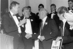 Gene Casey reacts as Bill O’Brien and close friend Larry McHugh congratulates him