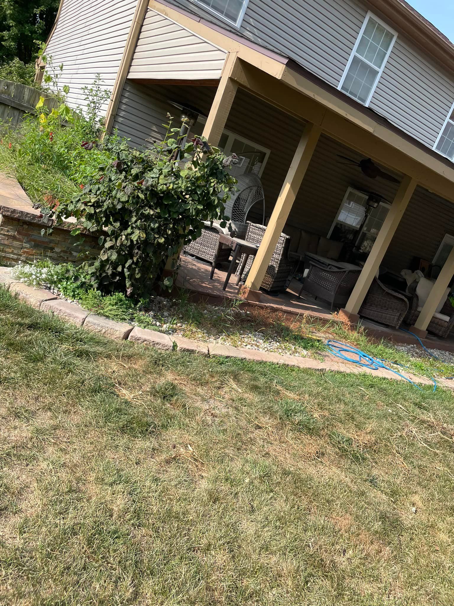 A house with a porch and a patio in the backyard.