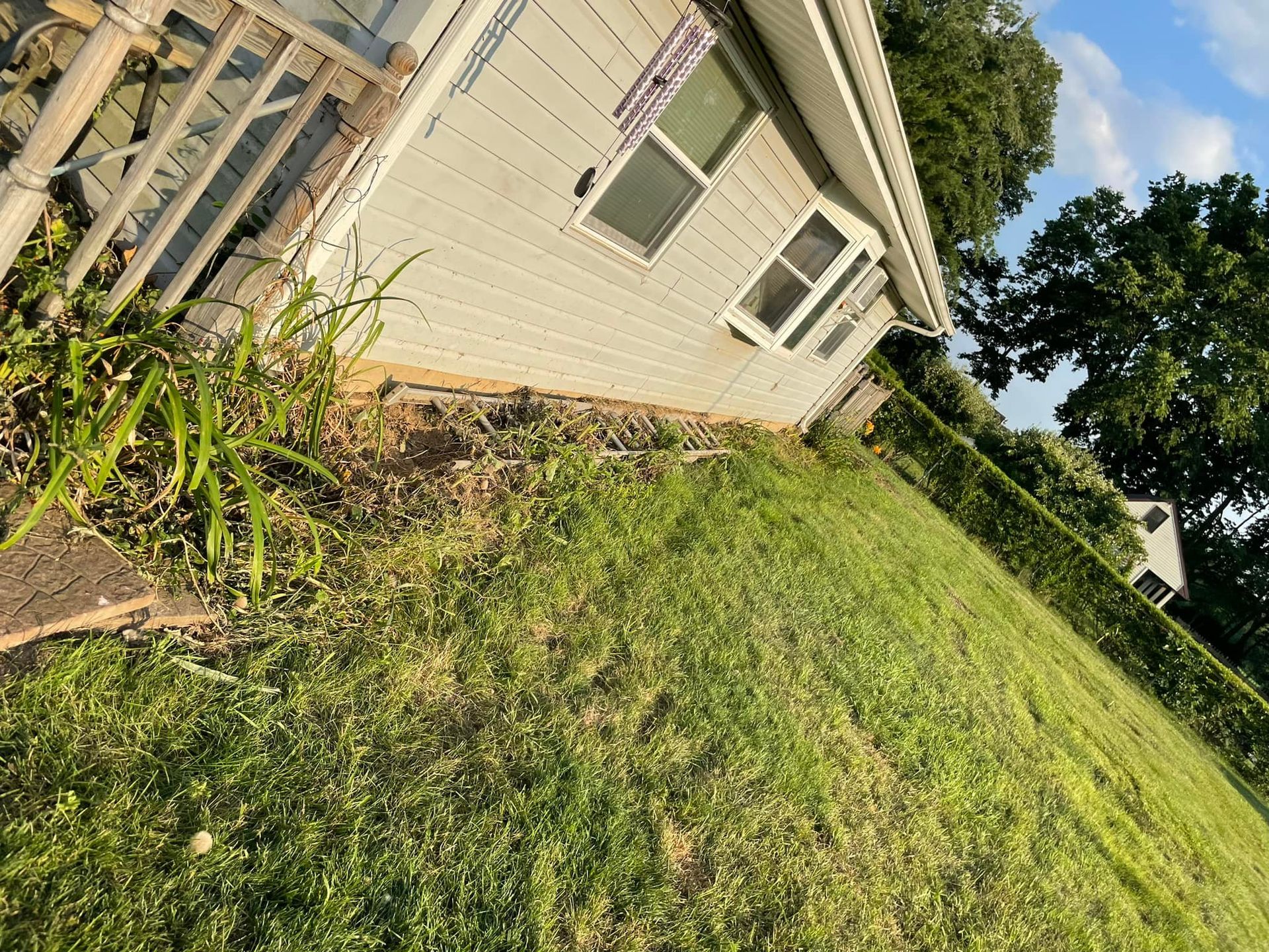 A white house with a lot of grass in front of it.