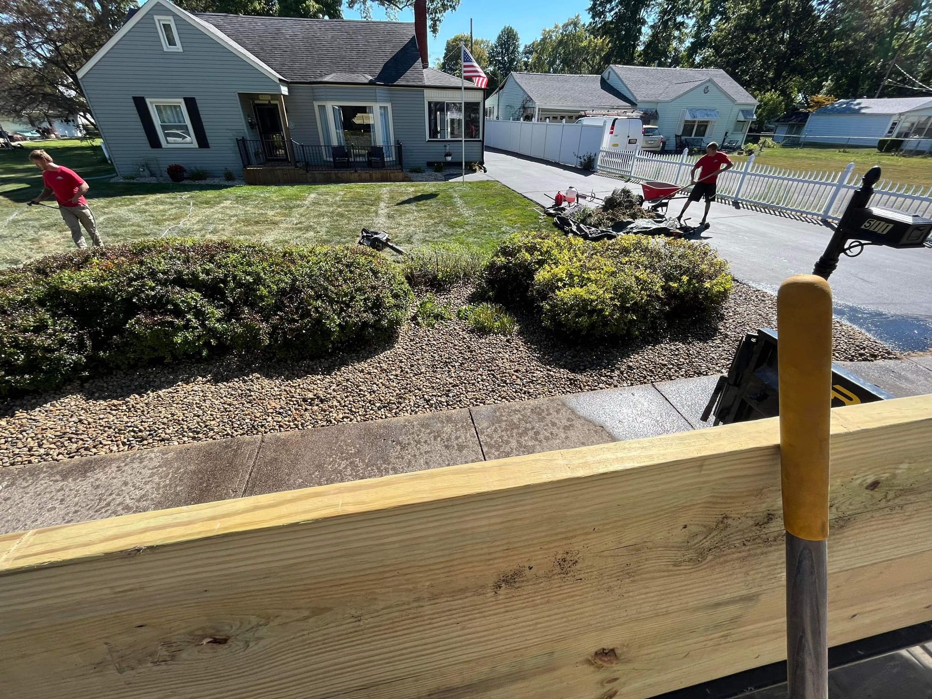 A wooden fence is being built in front of a house.