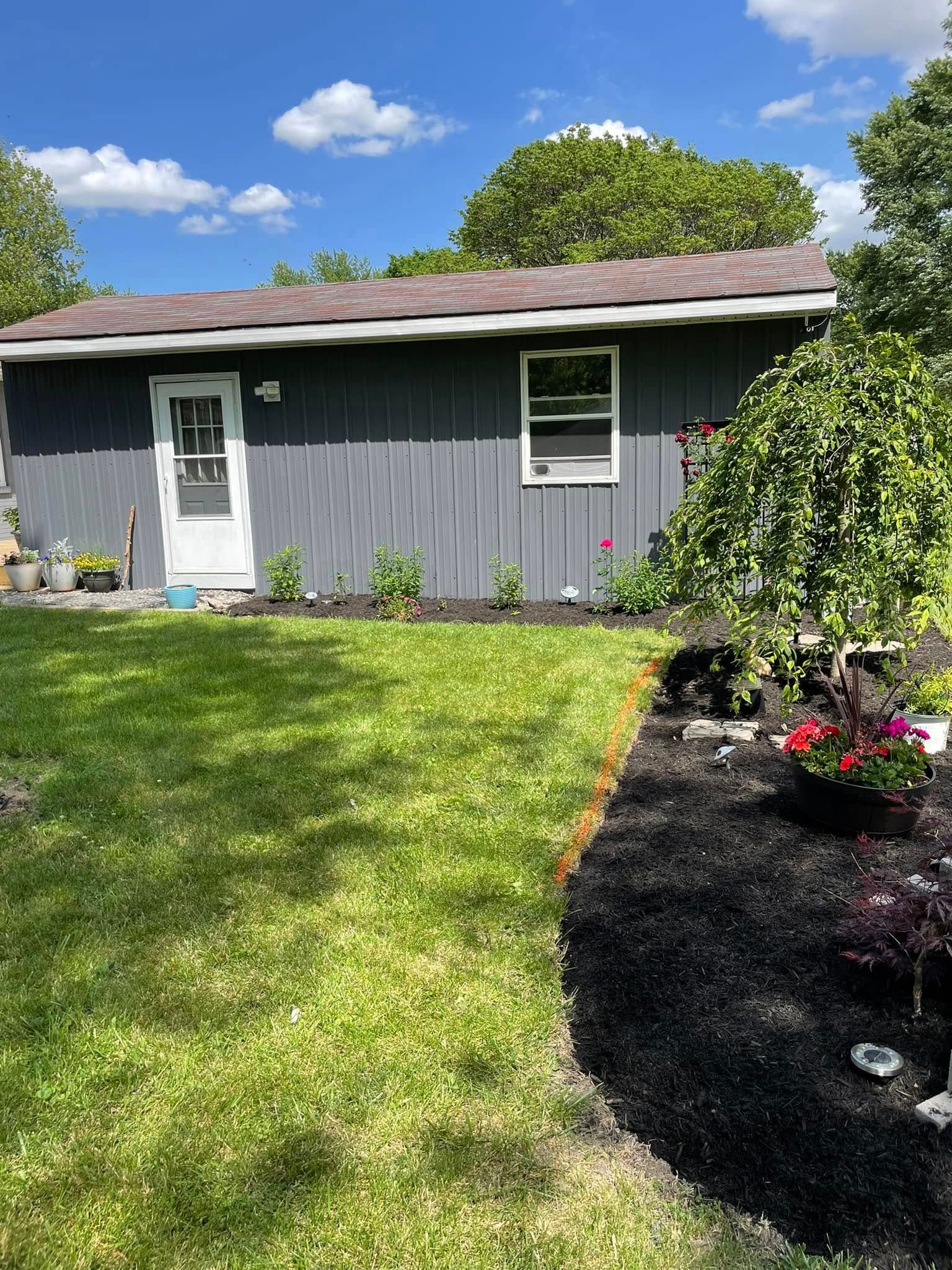 A small house with a large lawn in front of it.