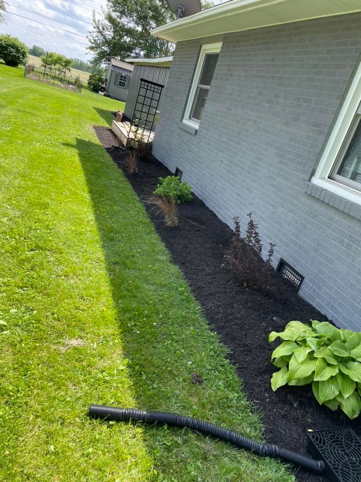 A vacuum cleaner is sitting in the grass next to a house.