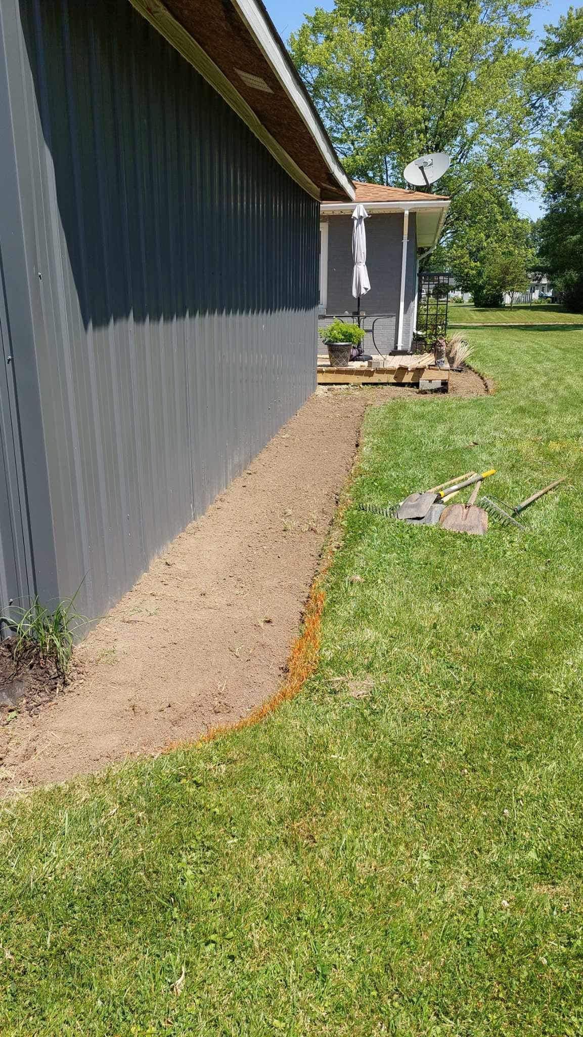 A sidewalk is being built in front of a house.