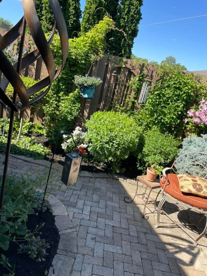 A patio with a bench and a windmill in the background