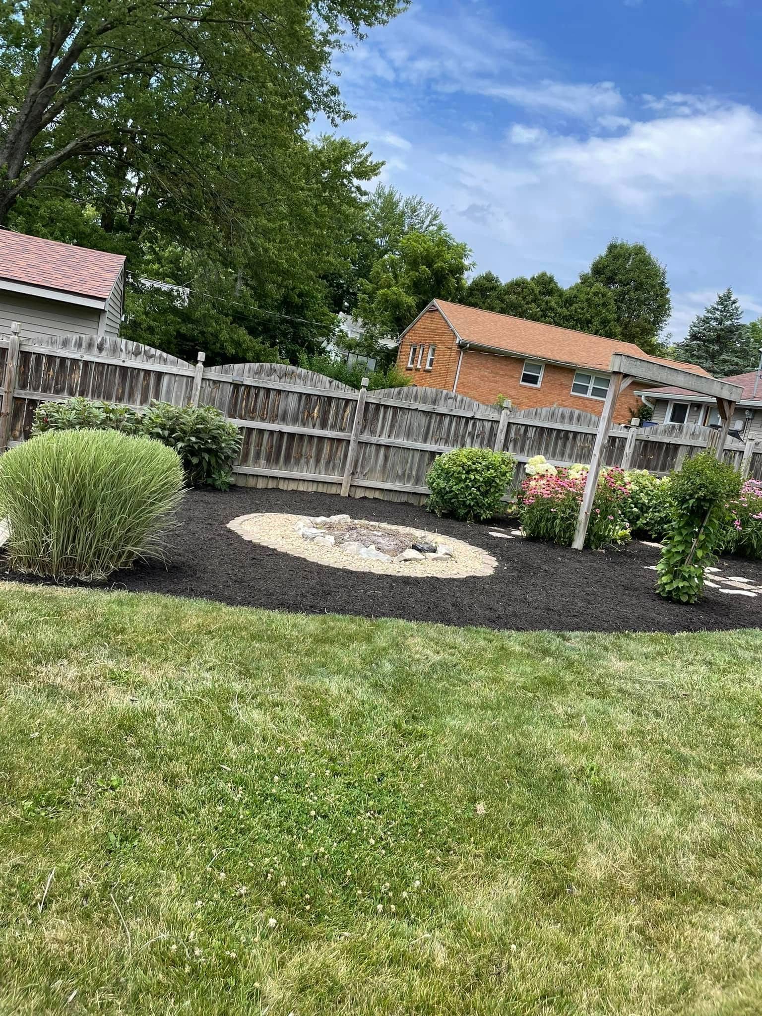 There is a fire pit in the middle of the yard.