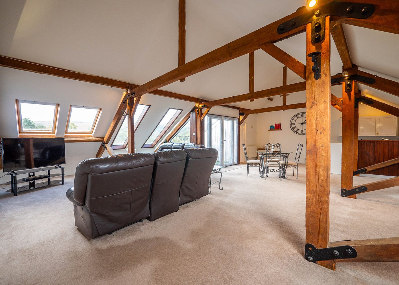 A living room with a couch , table and television.