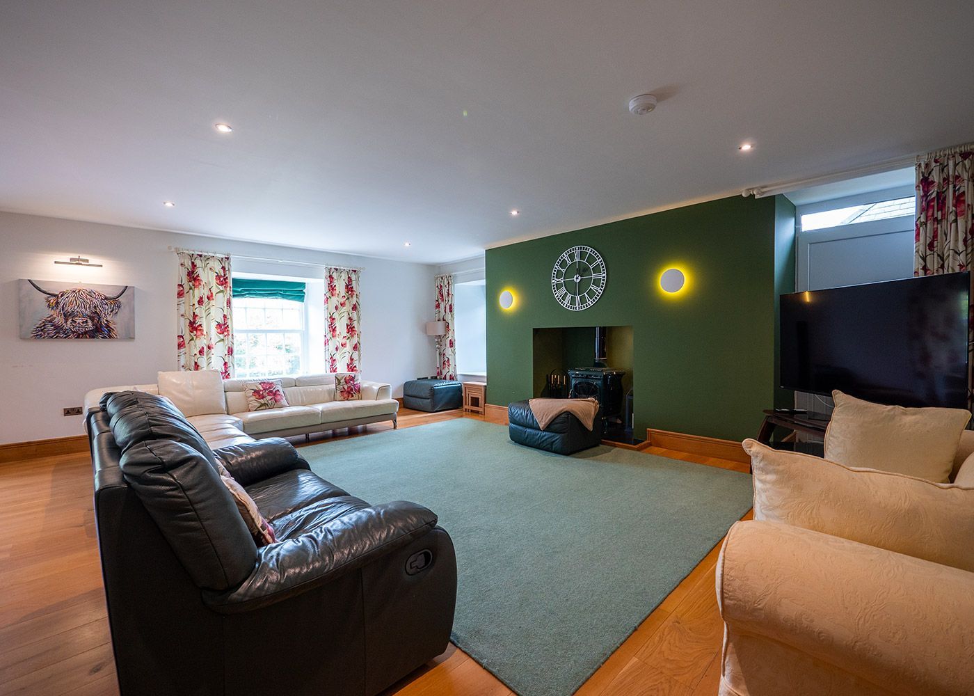 A living room with a couch , chairs , and a fireplace.