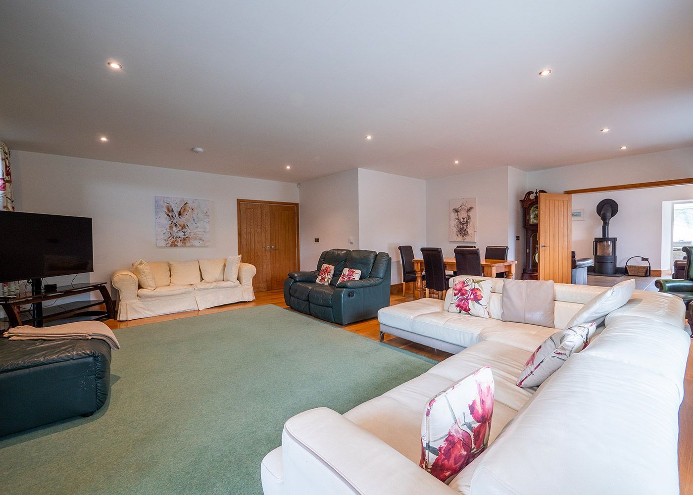 A living room filled with furniture and a television.