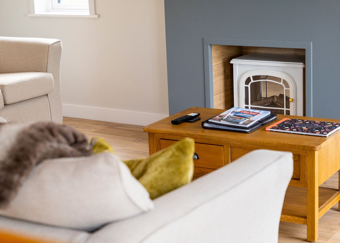 A living room with a fireplace and a coffee table