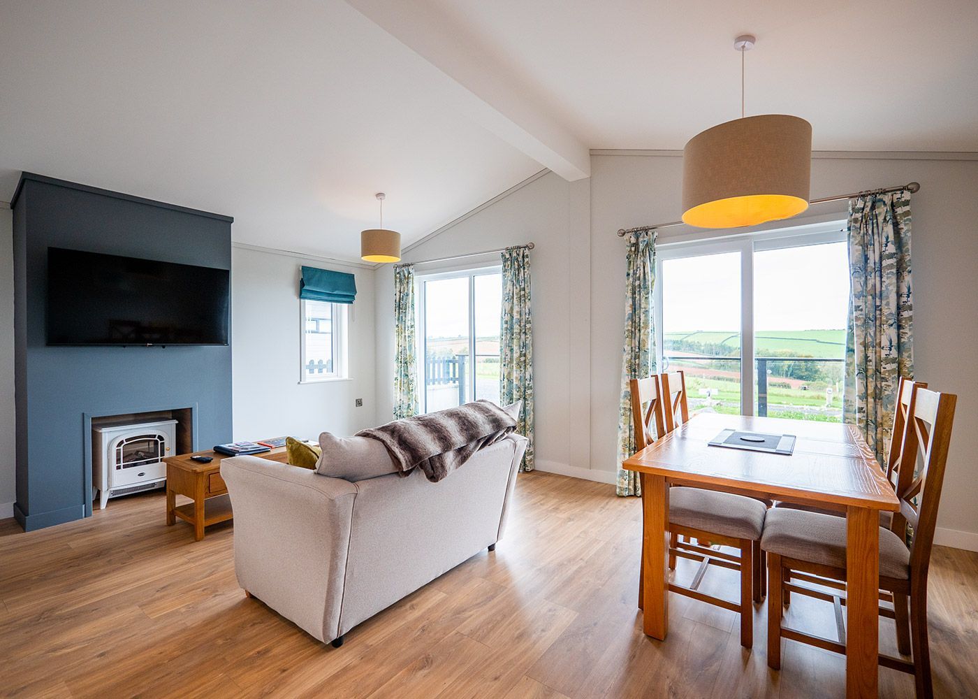 A living room with a couch , table and chairs.