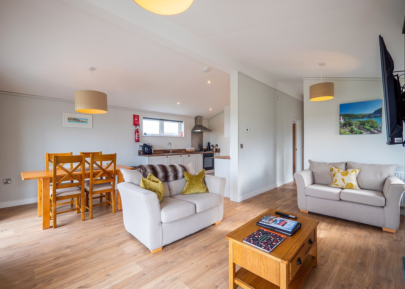 A living room with a couch , table and chairs.