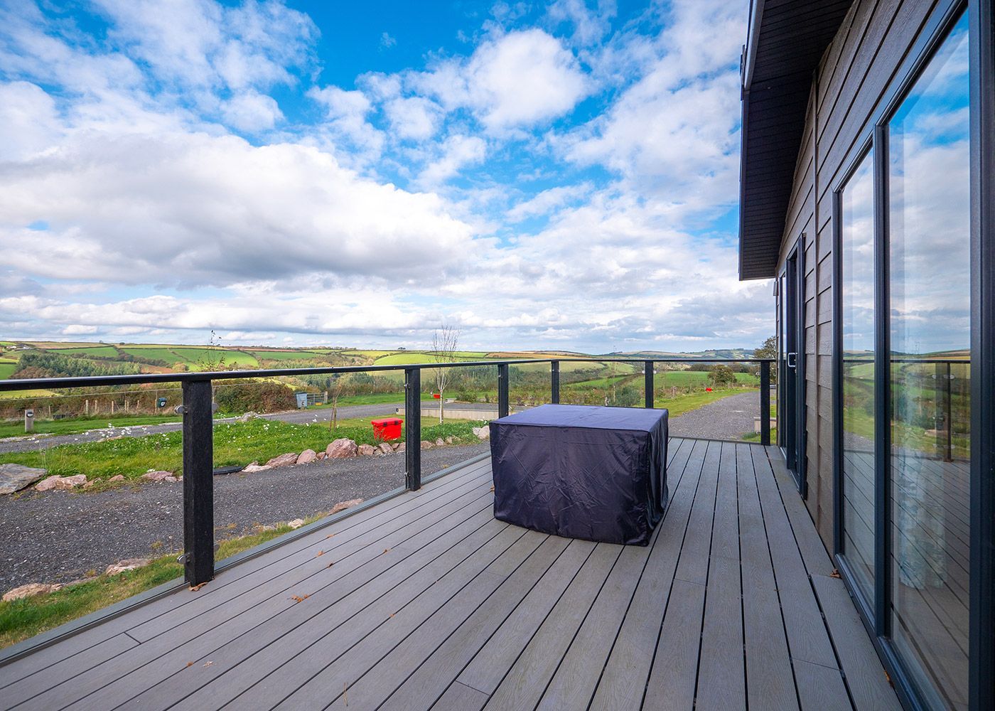 A large deck with a table and chairs on it.