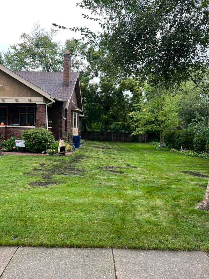 A house with a large lawn in front of it.