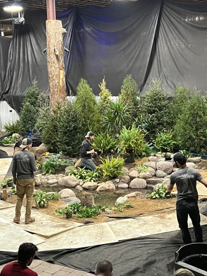 A group of people are working on a garden in a building.
