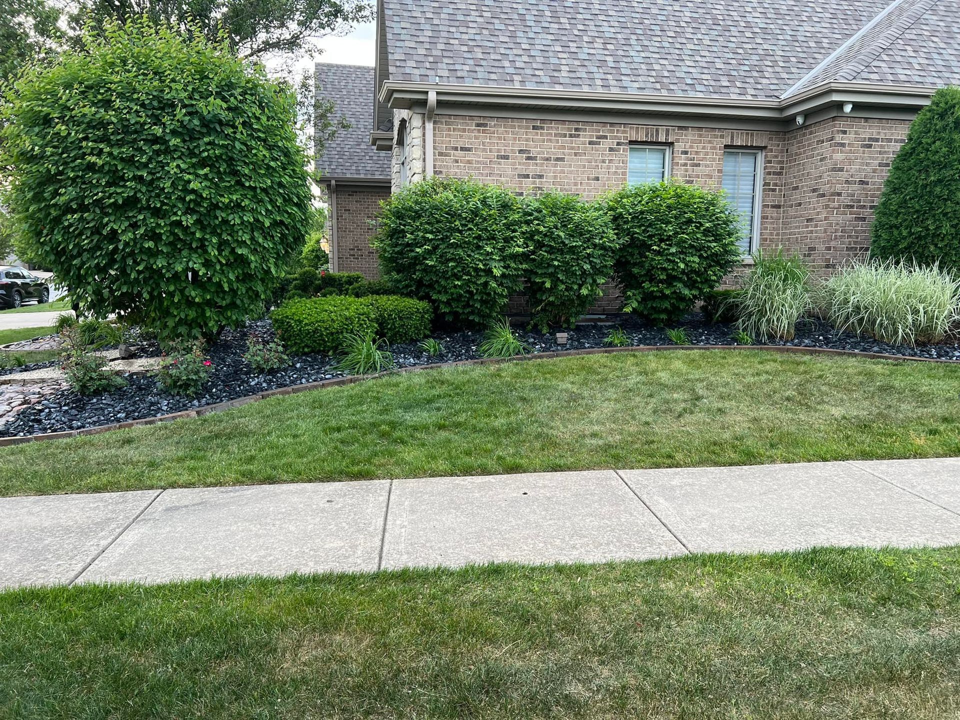 A large house with a lot of windows and a garage on a rainy day.