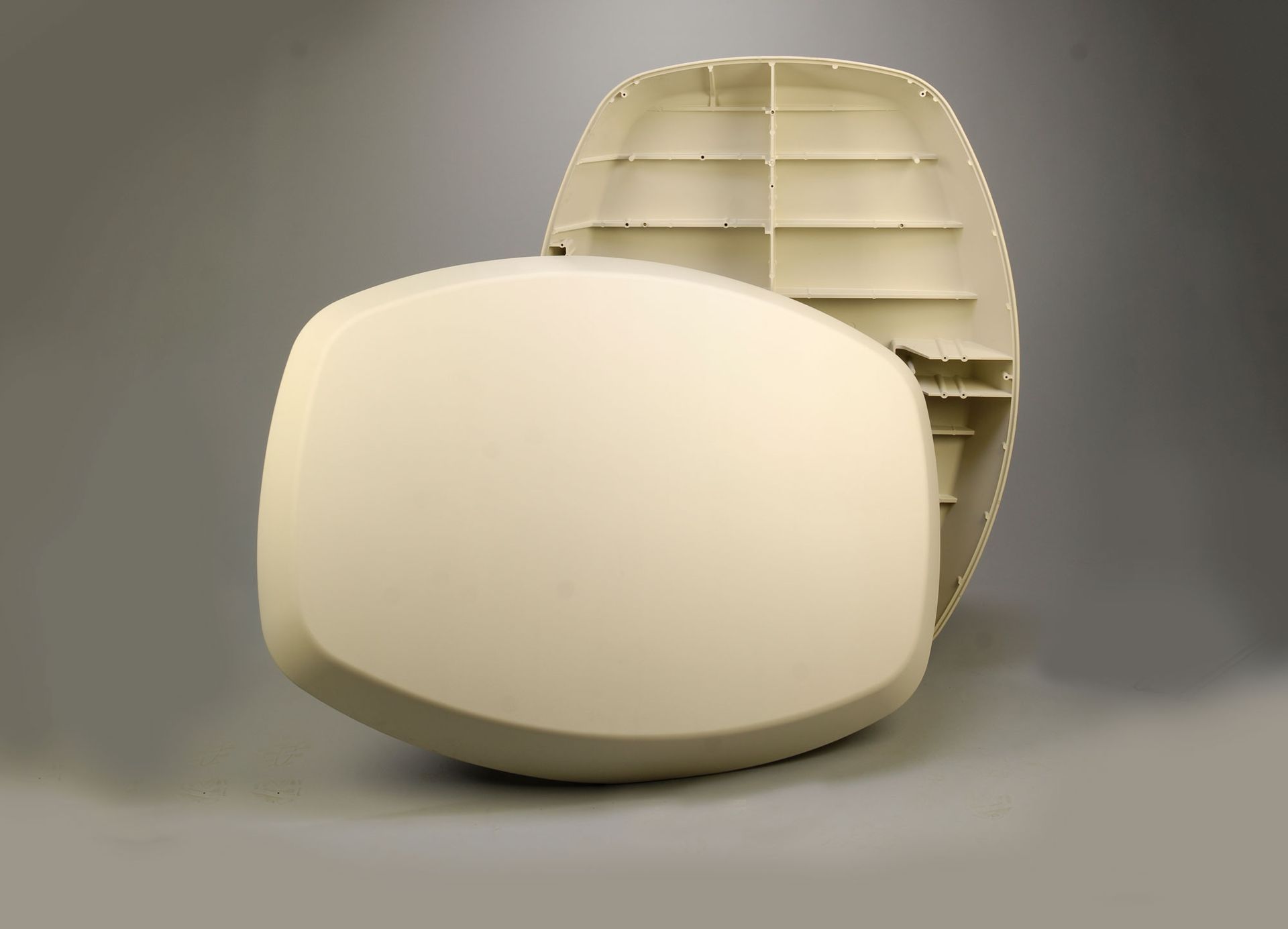 Two white plastic objects are sitting on a gray surface