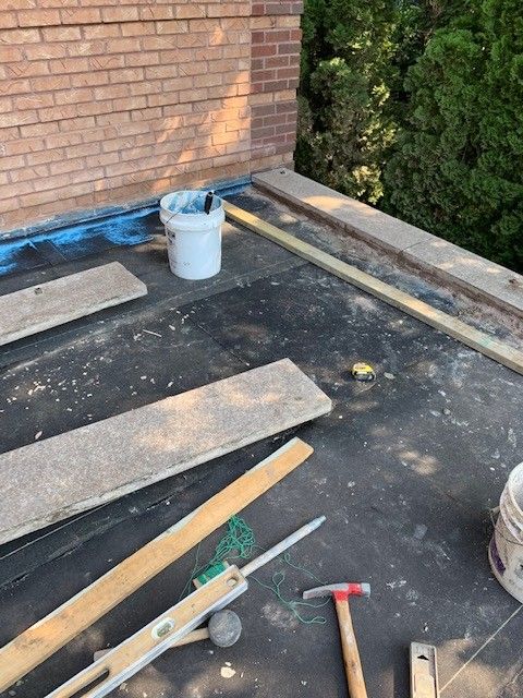 A roof with a lot of wood and tools on it