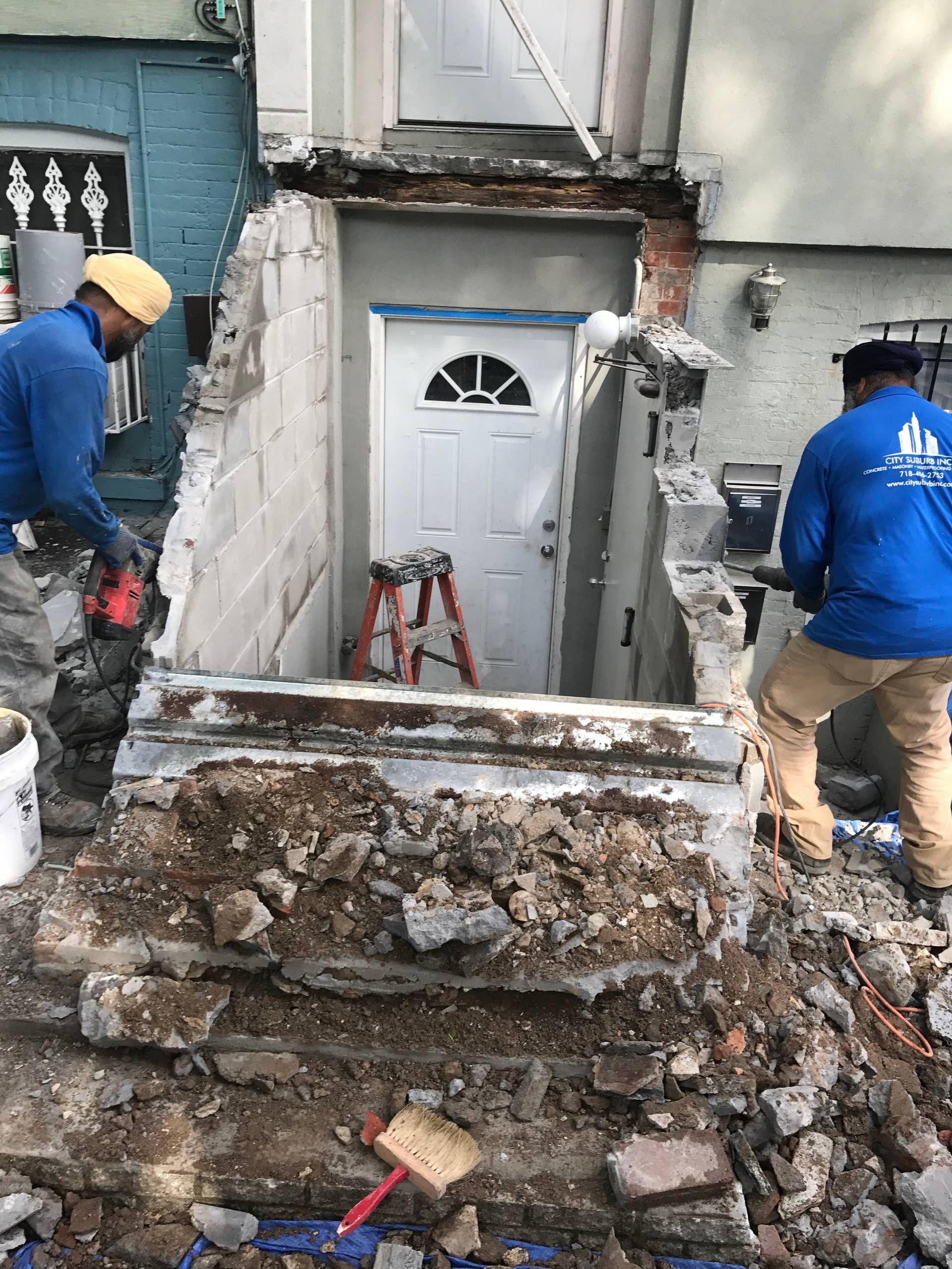 A group of construction workers are working on a building.