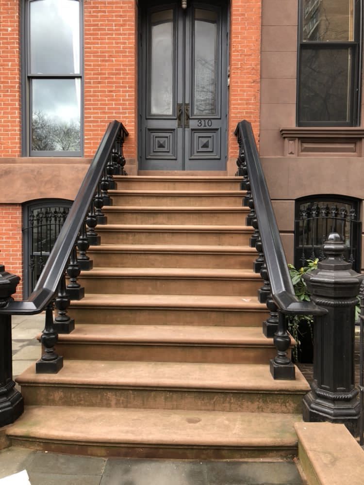 A set of stairs leading up to a brick building