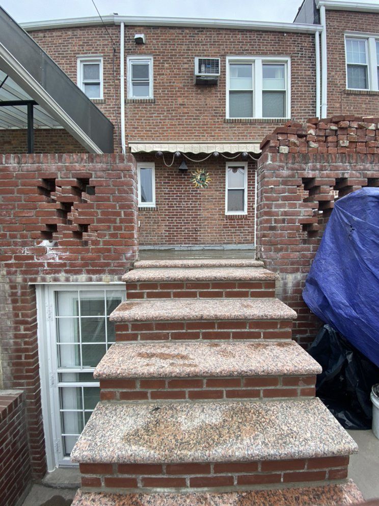 A brick building with stairs leading up to it