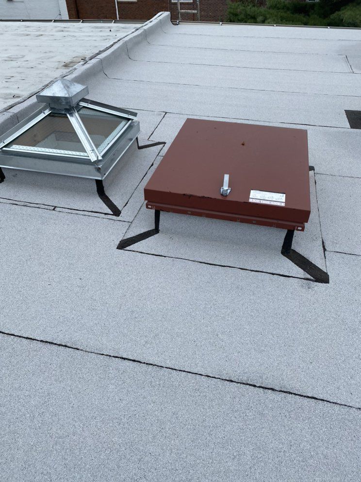 There are two skylights on the roof of a building.