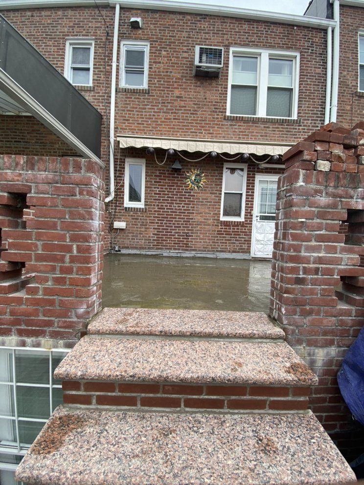 A brick building with stairs leading up to it