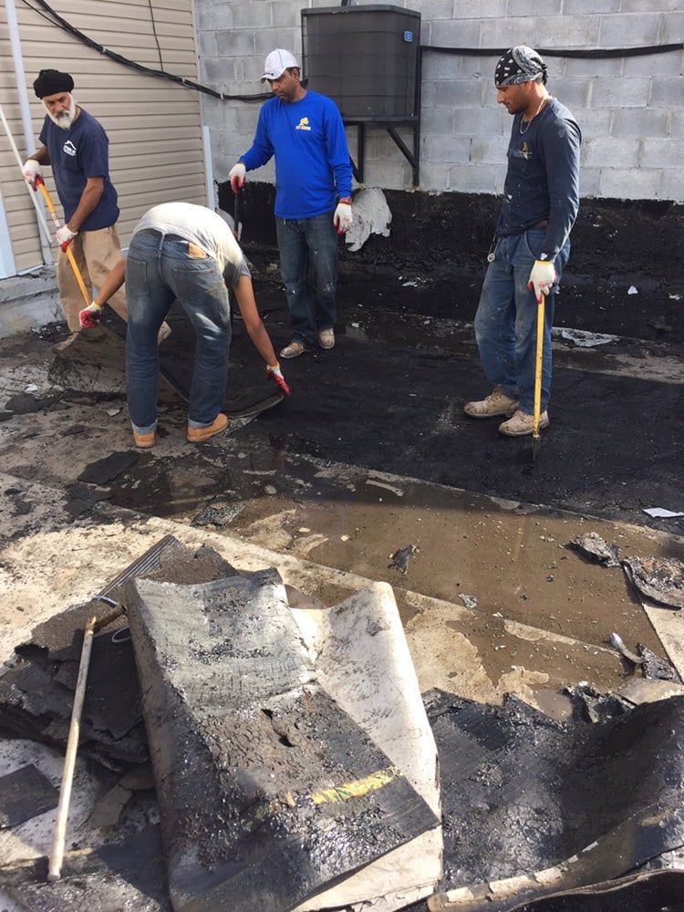 A group of men are working on a roof.