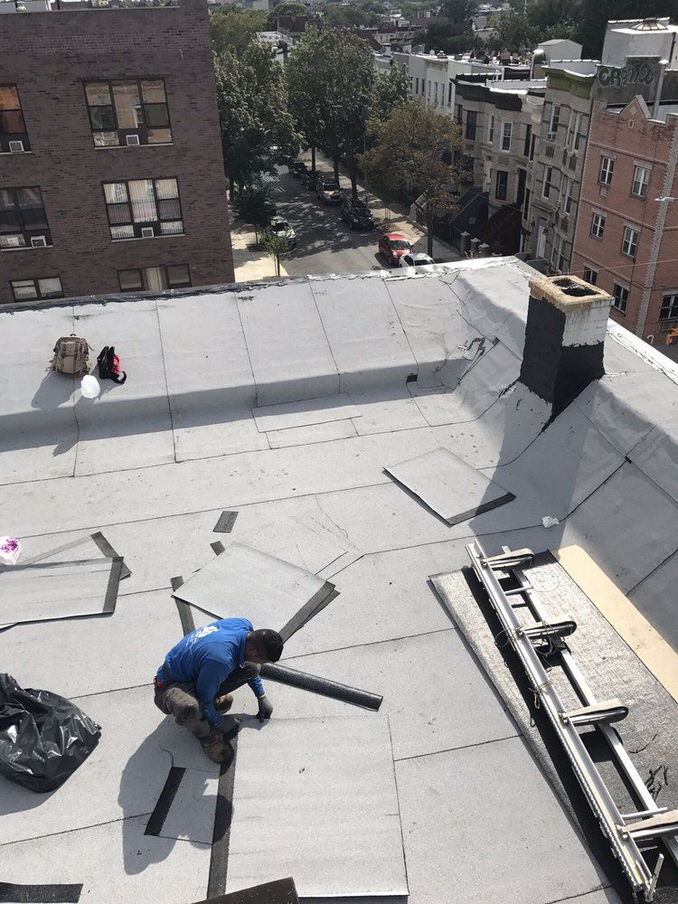 A man is working on the roof of a building