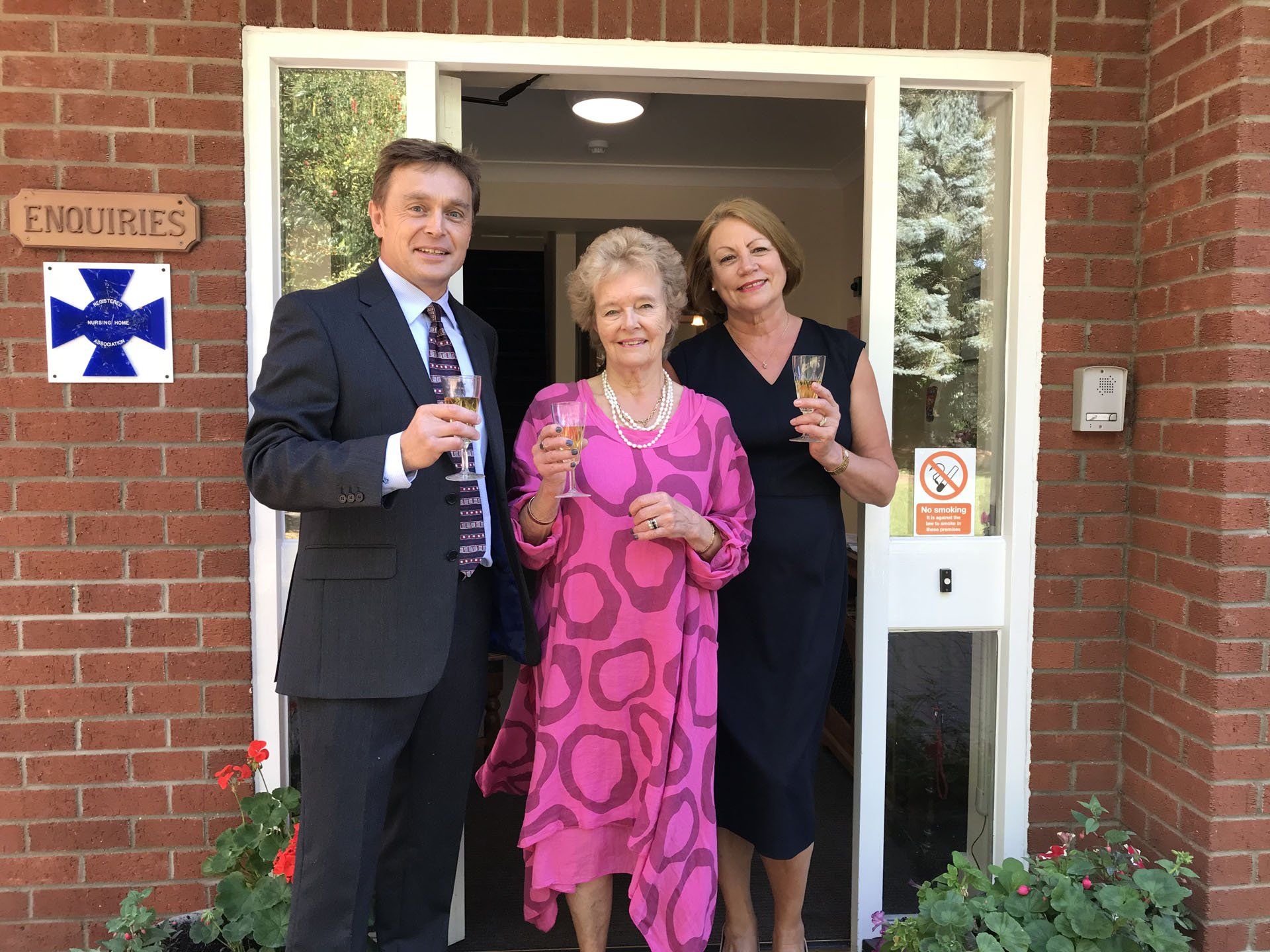 3 people with wine glasses, smiling