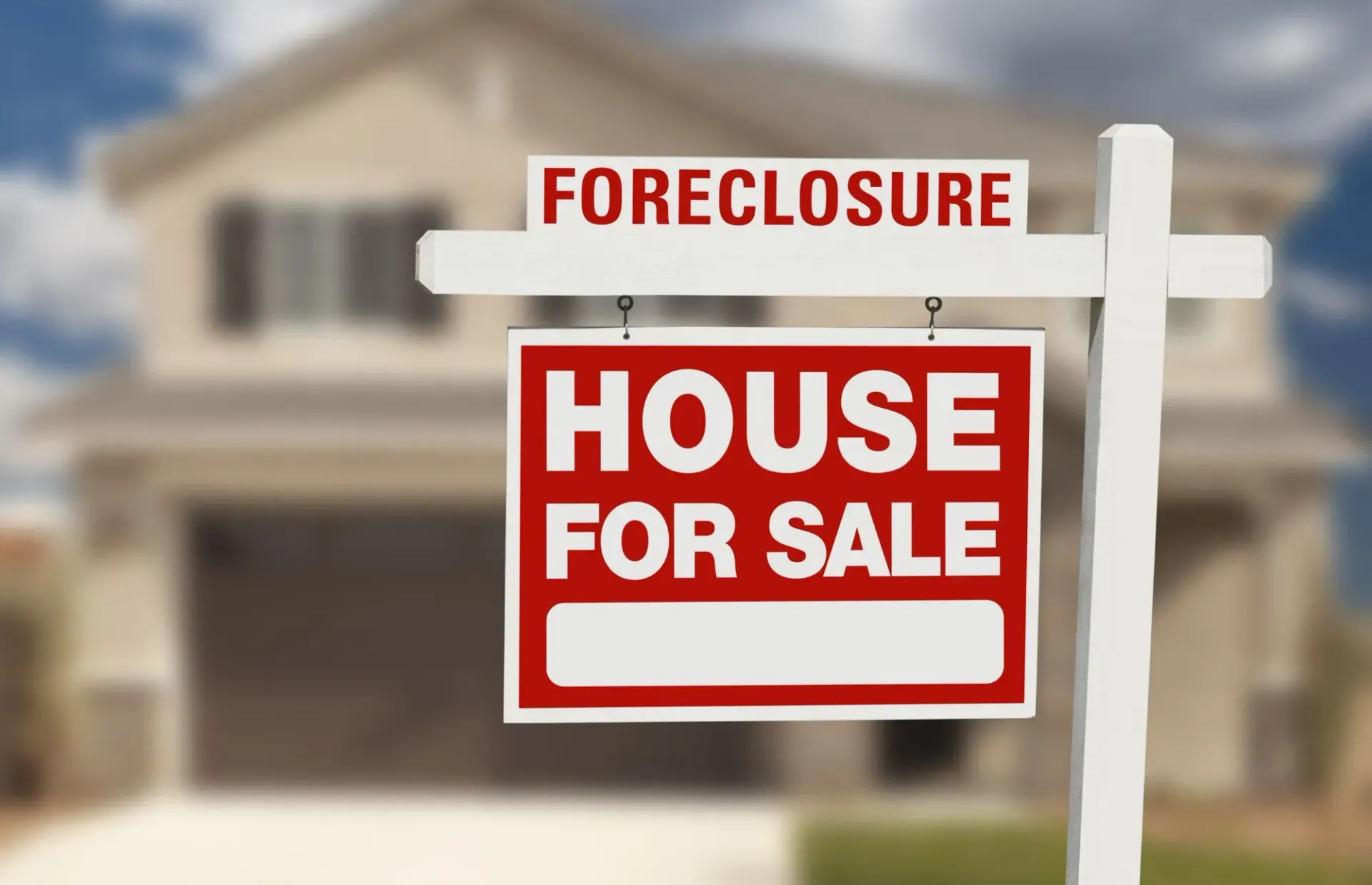 A foreclosure house for sale sign in front of a house