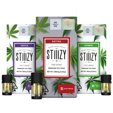 Stiiizy cannabis product packaging, including pods and boxes labeled Indica, Sativa, and Hybrid.