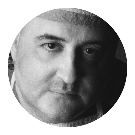 A black and white photo of a man 's face in a circle