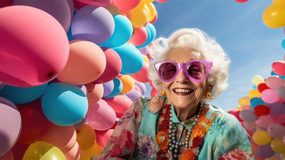 Happy senior woman with balloons around her