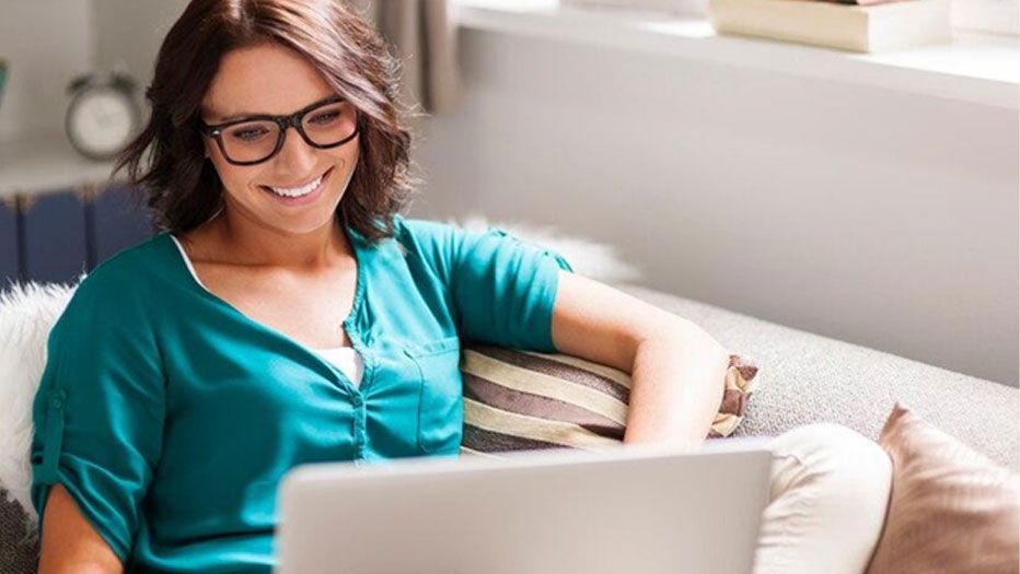Young women with glasses looking at computer.