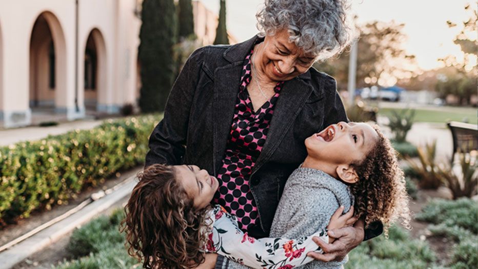 Senior woman holding her grandkids