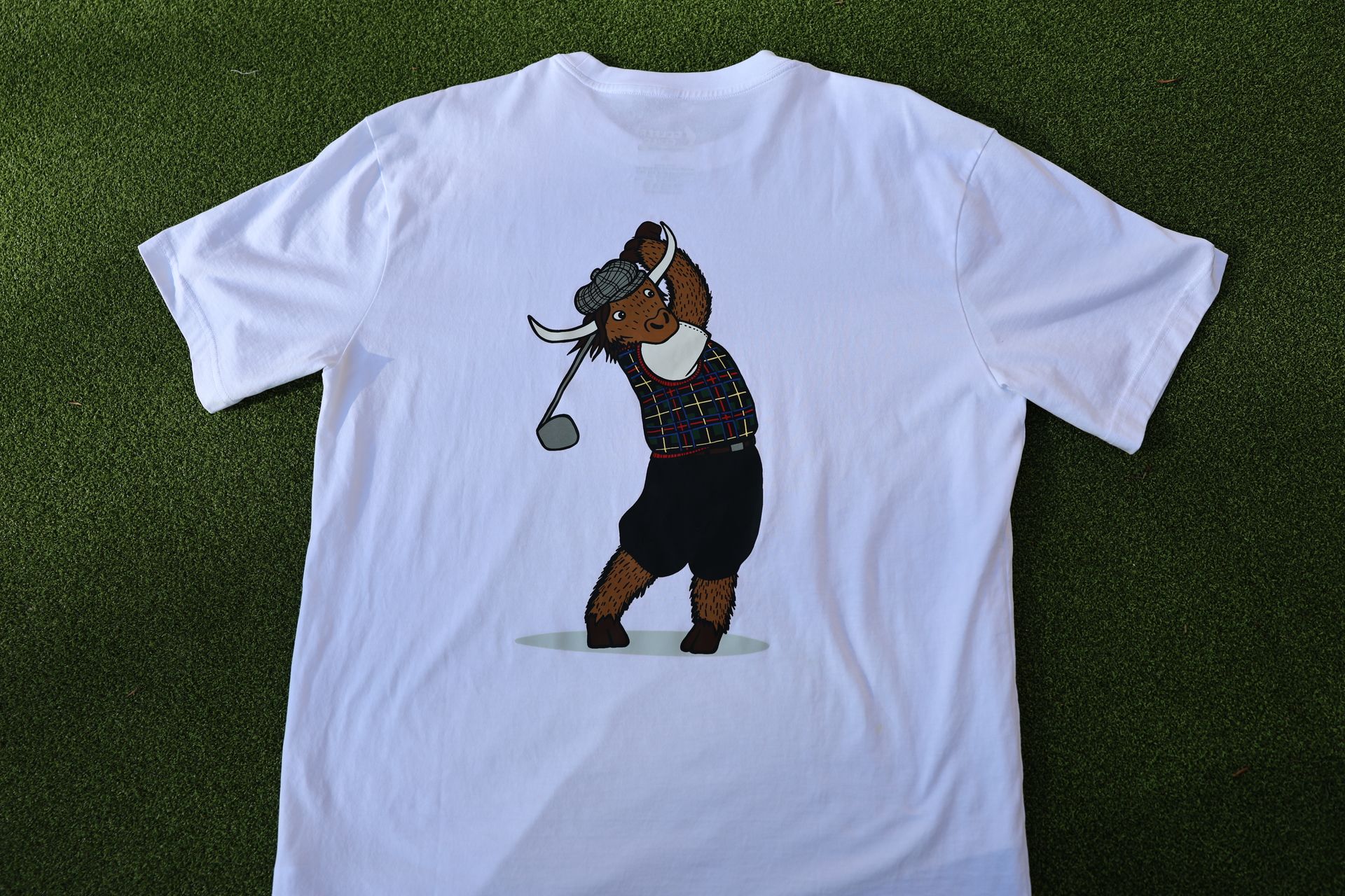 Golfer Guild SUPIMA® cotton Tartan Swinger tee with highland cow golfing animal art by Jonas Claesson.