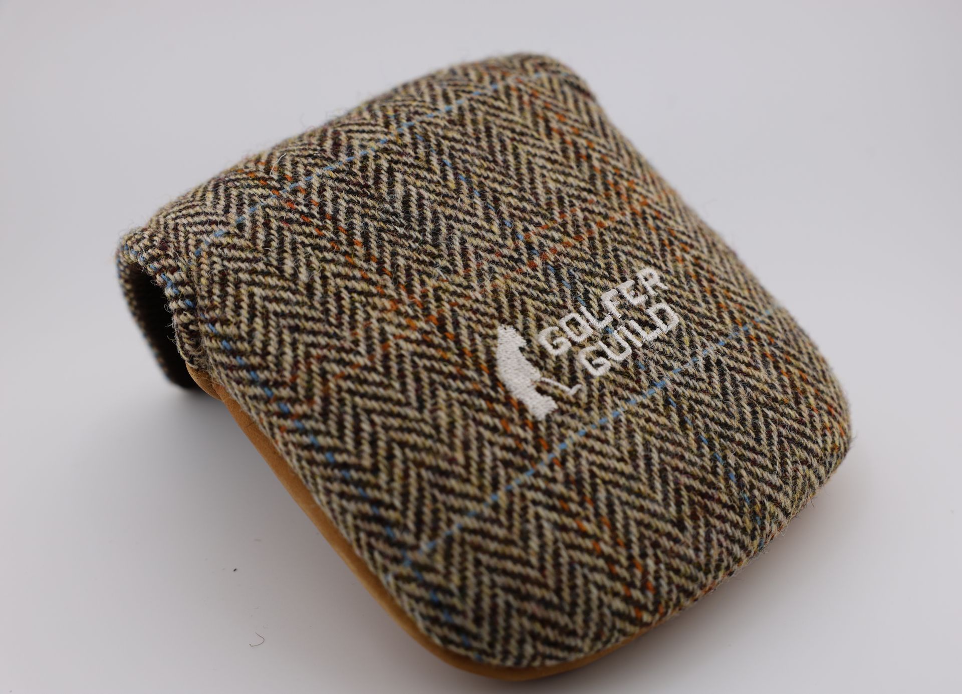 Golfer Guild Glen Plaid Harris Tweed hand-woven fabric with Jonas Claesson golfing animal art.