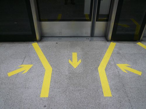 Yellow Arrows Are Painted On The Floor In Front Of An Elevator - Bolingbrook, IL - Master Locksmithing Inc