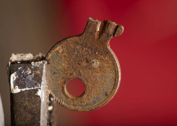 A Close Up Of A Rusty Key On A Red Background - Bolingbrook, IL - Master Locksmithing Inc