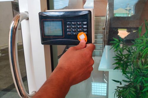 A Person Is Using A Key Card To Open A Door - Bolingbrook, IL - Master Locksmithing Inc