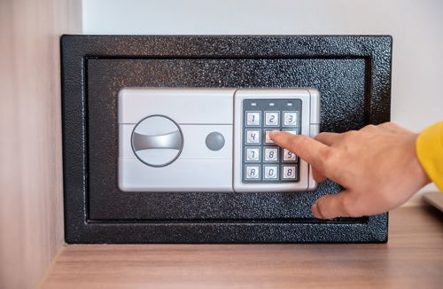 A Person Is Pressing A Button On A Safe With Their Finger - Bolingbrook, IL - Master Locksmithing Inc