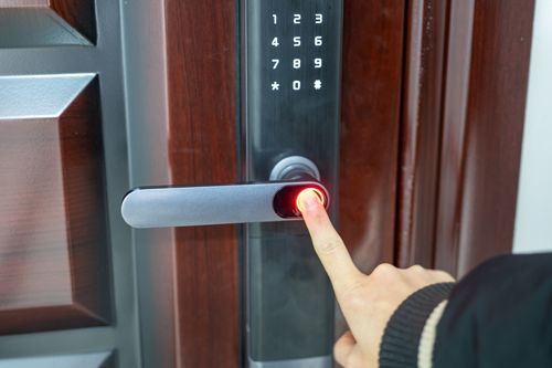 A Person Is Pressing A Button On A Door Lock With Their Finger - Bolingbrook, IL - Master Locksmithing Inc