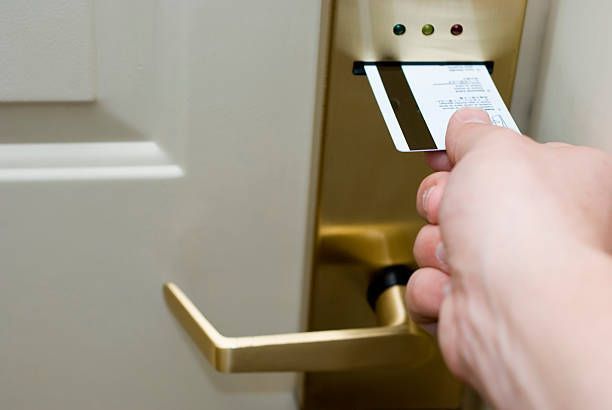 A Person Is Inserting A Credit Card Into A Door Lock - Bolingbrook, IL - Master Locksmithing Inc