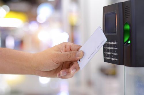 A Person Is Using A Fingerprint Scanner To Unlock A Door - Bolingbrook, IL - Master Locksmithing Inc