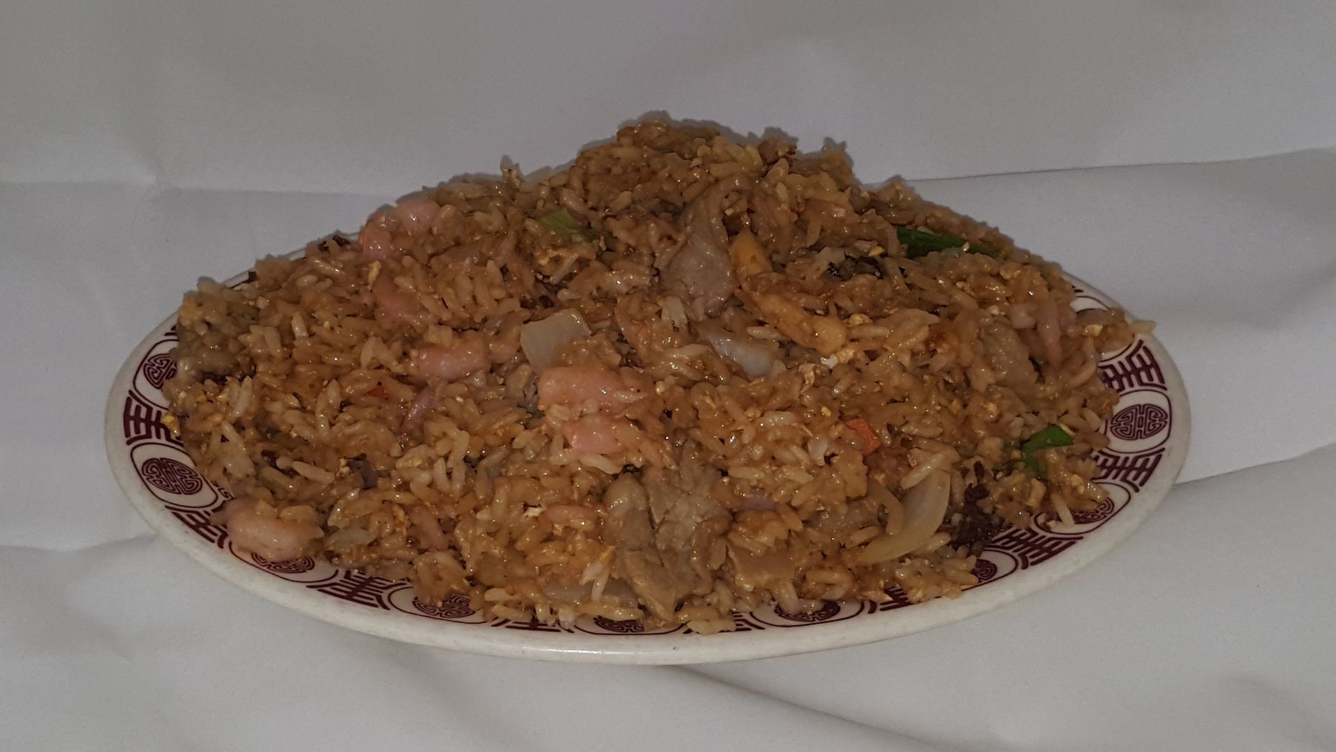 Plate of fried rice with shrimp and meat.