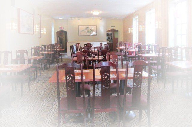 A blurry picture of a restaurant with tables and chairs