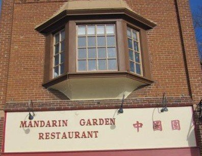 A brick building with a sign that says Mandarin Garden Restaurant