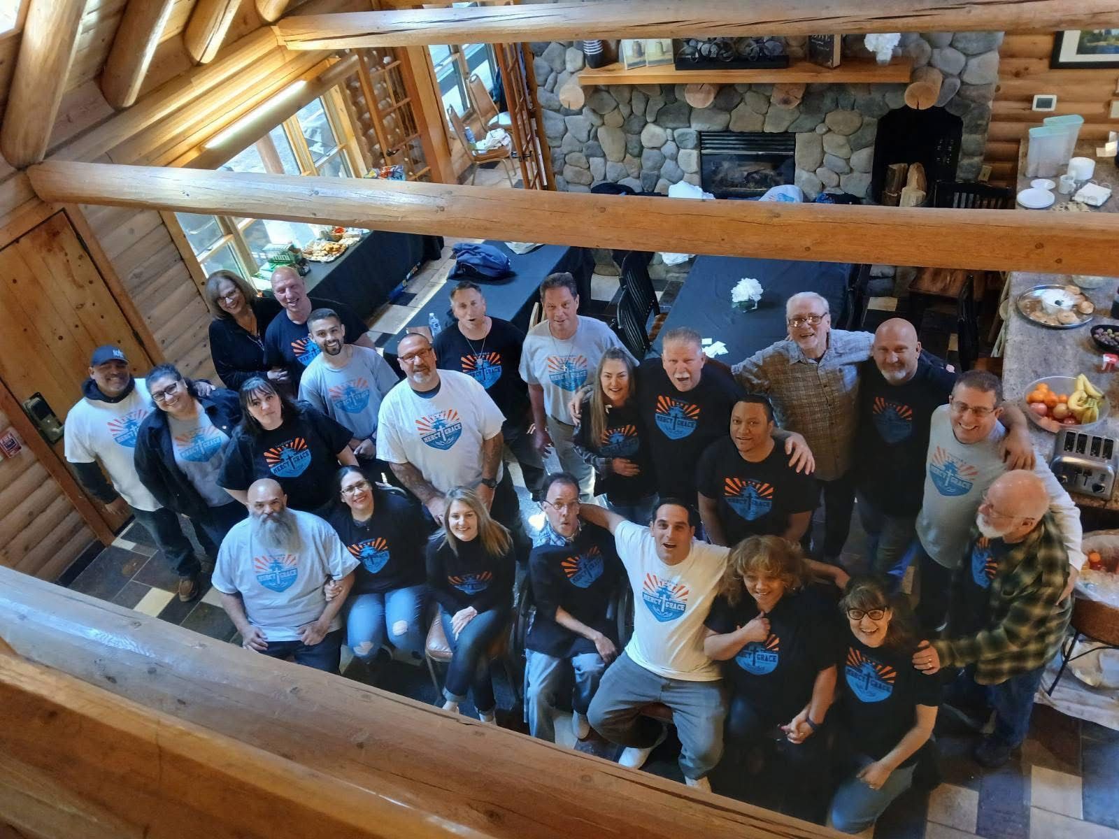 Large event hall with many people seated at round tables; stage at front with screens and performers.