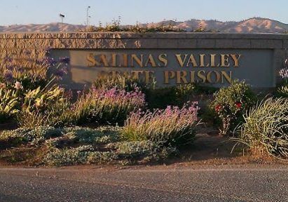 Sign for Salinas Valley State Prison with floral landscaping.